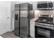 Functional kitchen equipped with stainless steel appliances and modern white cabinets at 4806 Forest Trl, Douglasville, GA 30135