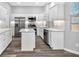 Bright kitchen featuring stainless steel appliances, white cabinetry, and a functional center island at 4806 Forest Trl, Douglasville, GA 30135