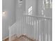 Staircase displaying white rails and a view of the modern lighting fixtures and window at 4806 Forest Trl, Douglasville, GA 30135