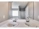 Bright bathroom featuring double sinks, large mirrors and updated fixtures at 4905 Martin Farms Dr, Powder Springs, GA 30127