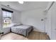 Cozy bedroom with wood floors, white walls, and a large window providing natural light at 4905 Martin Farms Dr, Powder Springs, GA 30127
