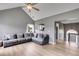Spacious living room with a plush gray sofa, vaulted ceiling, and natural light from a large window at 4905 Martin Farms Dr, Powder Springs, GA 30127