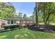 Large backyard with manicured lawn and established landscaping enhance this home's curb appeal at 839 Cardova Ne Dr, Atlanta, GA 30324