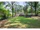 Expansive backyard featuring lush green grass, mature trees, and a storage shed at 839 Cardova Ne Dr, Atlanta, GA 30324