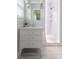 Bright bathroom featuring white tiling, sleek vanity with good storage, and a glass-enclosed shower at 839 Cardova Ne Dr, Atlanta, GA 30324
