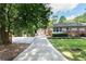 Back exterior showing well-kept lawn and garden area plus a detached storage shed at 839 Cardova Ne Dr, Atlanta, GA 30324