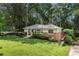 Charming single-story home with a brick facade, manicured lawn, and mature trees at 839 Cardova Ne Dr, Atlanta, GA 30324