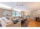 Spacious living area with a comfortable sectional, modern ceiling fan, and views of the outdoors at 839 Cardova Ne Dr, Atlanta, GA 30324