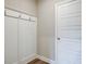Mud room features wood floors, hooks for hanging items, and a white door at 11 Butternut Way, Auburn, GA 30011