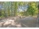 Spacious backyard featuring a concrete patio, bordered by a chain-link fence and surrounded by mature trees at 270 Bromack Se Dr, Atlanta, GA 30315