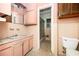 Retro bathroom featuring pink tiles, an ornate sink, and a shower/tub at 270 Bromack Se Dr, Atlanta, GA 30315