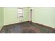 The bedroom has light green walls, a window for natural light, and a closet for storage at 270 Bromack Se Dr, Atlanta, GA 30315