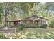 Cozy stone cottage-style home with a covered parking area nestled among mature trees at 270 Bromack Se Dr, Atlanta, GA 30315