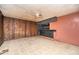 View of the living room with panel walls, tile flooring, ceiling fan and a wet bar at 270 Bromack Se Dr, Atlanta, GA 30315