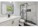 Sleek bathroom featuring glass shower, modern fixtures, and black herringbone tile at 3530 Boulder Cir, Ellenwood, GA 30294