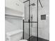 Modern bathroom featuring glass shower, sleek fixtures, and storage at 3530 Boulder Cir, Ellenwood, GA 30294