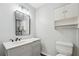 Modern bathroom featuring a vanity, toilet, and framed mirror at 3530 Boulder Cir, Ellenwood, GA 30294
