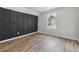 Modern bedroom with wood accent wall and hardwood floors at 3530 Boulder Cir, Ellenwood, GA 30294