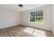 Bright bedroom with hardwood floors and a large window at 3530 Boulder Cir, Ellenwood, GA 30294