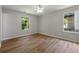 Bedroom featuring hardwood floors, a ceiling fan, and two windows at 3530 Boulder Cir, Ellenwood, GA 30294