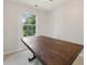 Dining room featuring a wood table, tile floors, and a bright window with outdoor views at 3530 Boulder Cir, Ellenwood, GA 30294