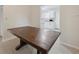Dining room showcasing a rustic wood table with kitchen view, neutral walls and tile flooring at 3530 Boulder Cir, Ellenwood, GA 30294