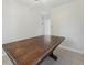 Dining room area showcasing a rustic wood table with neutral walls and tile flooring at 3530 Boulder Cir, Ellenwood, GA 30294