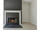 Cozy fireplace with black tile surround and a white mantel in a neutrally colored living room at 3530 Boulder Cir, Ellenwood, GA 30294
