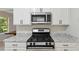 Modern kitchen with stainless steel appliances and granite countertops at 3530 Boulder Cir, Ellenwood, GA 30294