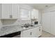 Bright kitchen with stainless steel sink, granite countertops, and white cabinets at 3530 Boulder Cir, Ellenwood, GA 30294