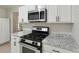 Stylish kitchen with white cabinets, granite countertops, and stainless steel oven at 3530 Boulder Cir, Ellenwood, GA 30294