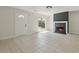 Bright living room featuring a fireplace, white door, neutral walls, and tile flooring at 3530 Boulder Cir, Ellenwood, GA 30294