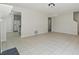 Neutral living room with tile flooring connecting to a kitchen with modern appliances, ideal for entertaining at 3530 Boulder Cir, Ellenwood, GA 30294