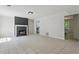 Inviting living room with a sleek black fireplace, neutral tile floors, and ample natural light at 3530 Boulder Cir, Ellenwood, GA 30294