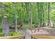 Gorgeous backyard featuring a stone walkway, fountain, and a secluded deck surrounded by lush trees at 4259 Arbor Club Dr, Marietta, GA 30066
