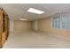 Spacious basement with plush carpeting, built-in bookshelves, and a window for natural light at 4259 Arbor Club Dr, Marietta, GA 30066