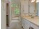 Well-lit bathroom showcasing a dual sink vanity, access to a walk-in closet, and a relaxing soaking tub at 4259 Arbor Club Dr, Marietta, GA 30066