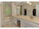 Bright bathroom featuring double sinks, a large mirror, and an adjacent tub and shower area at 4259 Arbor Club Dr, Marietta, GA 30066