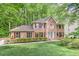 Charming brick two-story home featuring manicured landscaping, a lush green lawn, and a welcoming front entrance at 4259 Arbor Club Dr, Marietta, GA 30066