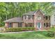 Charming brick two-story home with a well-manicured lawn and beautiful green trees at 4259 Arbor Club Dr, Marietta, GA 30066