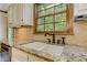 Kitchen sink featuring granite countertop and wooden trim at 4259 Arbor Club Dr, Marietta, GA 30066