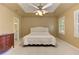 Spacious main bedroom features a tray ceiling with fan and a comfortable, upholstered bed at 4259 Arbor Club Dr, Marietta, GA 30066