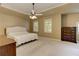 Generous main bedroom with tray ceiling, ceiling fan, plush carpet, and traditional wood dresser at 4259 Arbor Club Dr, Marietta, GA 30066