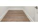Neutral area in a basement with light hardwood floors and white baseboards at 105 Cumming St, Alpharetta, GA 30009