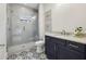 Chic bathroom with a glass shower, granite countertops, and stylish patterned flooring at 105 Cumming St, Alpharetta, GA 30009
