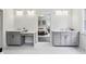 Luxurious bathroom with double sinks, stylish vanity, and an open doorway to a bedroom at 105 Cumming St, Alpharetta, GA 30009