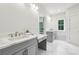 Spacious bathroom with double vanity sinks, ample counter space, and bright natural light at 105 Cumming St, Alpharetta, GA 30009