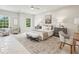 Bright bedroom featuring stylish seating area and large windows overlooking a wooded area at 105 Cumming St, Alpharetta, GA 30009