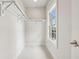 Bright, walk-in closet featuring ample shelving, natural light from a window, and neutral tones at 105 Cumming St, Alpharetta, GA 30009