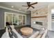 Inviting covered patio with fireplace, outdoor seating, and access to the home's interior at 105 Cumming St, Alpharetta, GA 30009